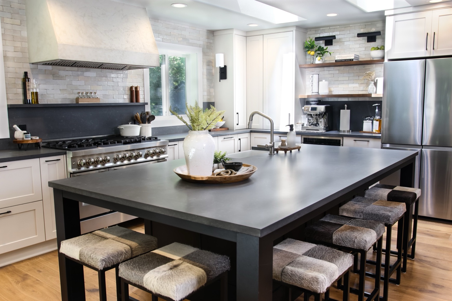 A completed kitchen with light cabinetry, natural wood accents, and a generous charcoal island